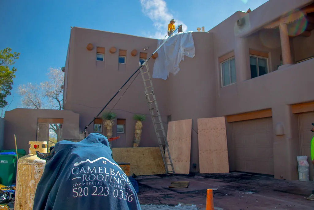 Roofer working on a southwestern adobe-style home