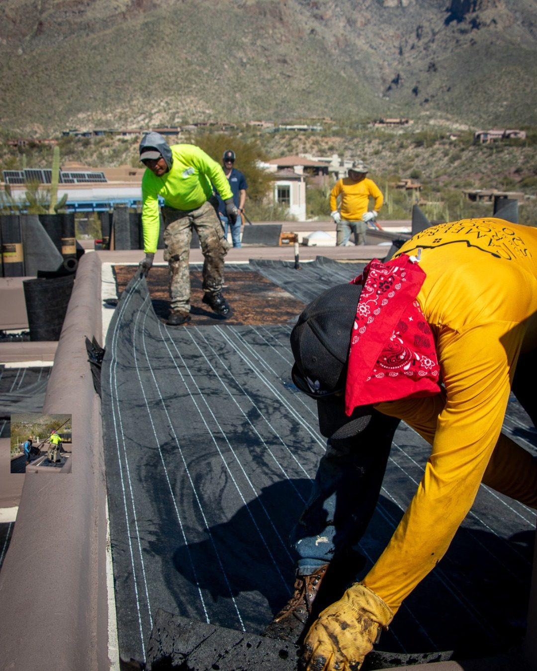 Crew installing a flat roof system in Tucson