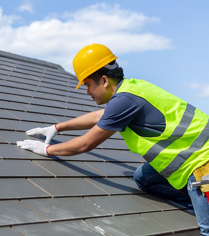 roofing contractor inspecting stone coated steal roof